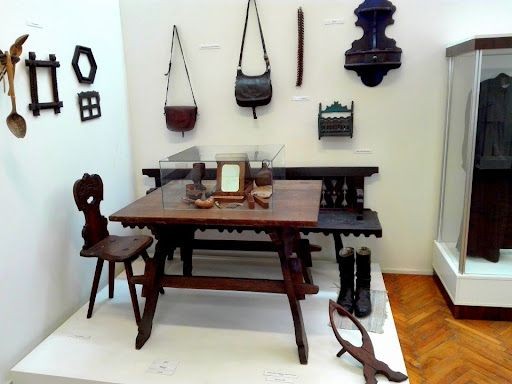 Régi parasztbútorok, ácsolt láda és parasztszék, kiállítás a helyi fafeldolgozás remekeiből